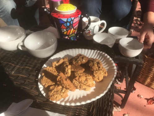 A proper tea with tea pot and fresh baked cookies.